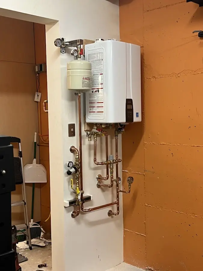 Plumbing technician inspecting water heater connections in Melbourne
